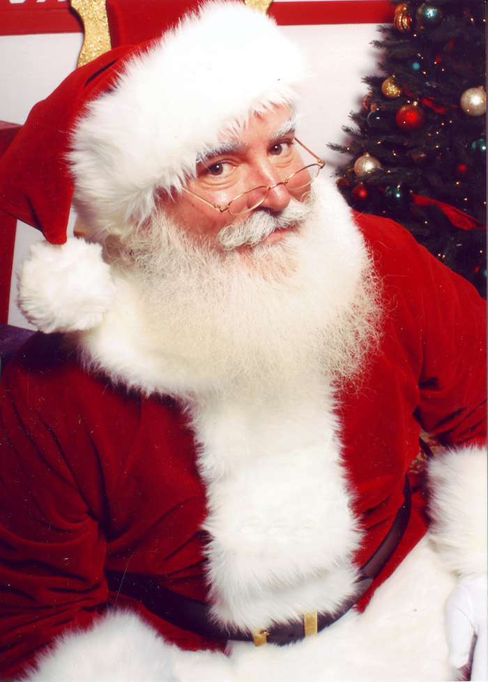 santa claus smiling and looking over his glasses