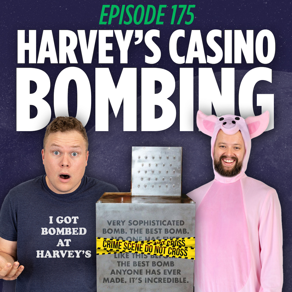 Jaron Myers and Tim Stone standing behind the harvey casino bomb. Jaron is wearing a tee that says I got bombed at harveys and tim is wearing a pig costume.