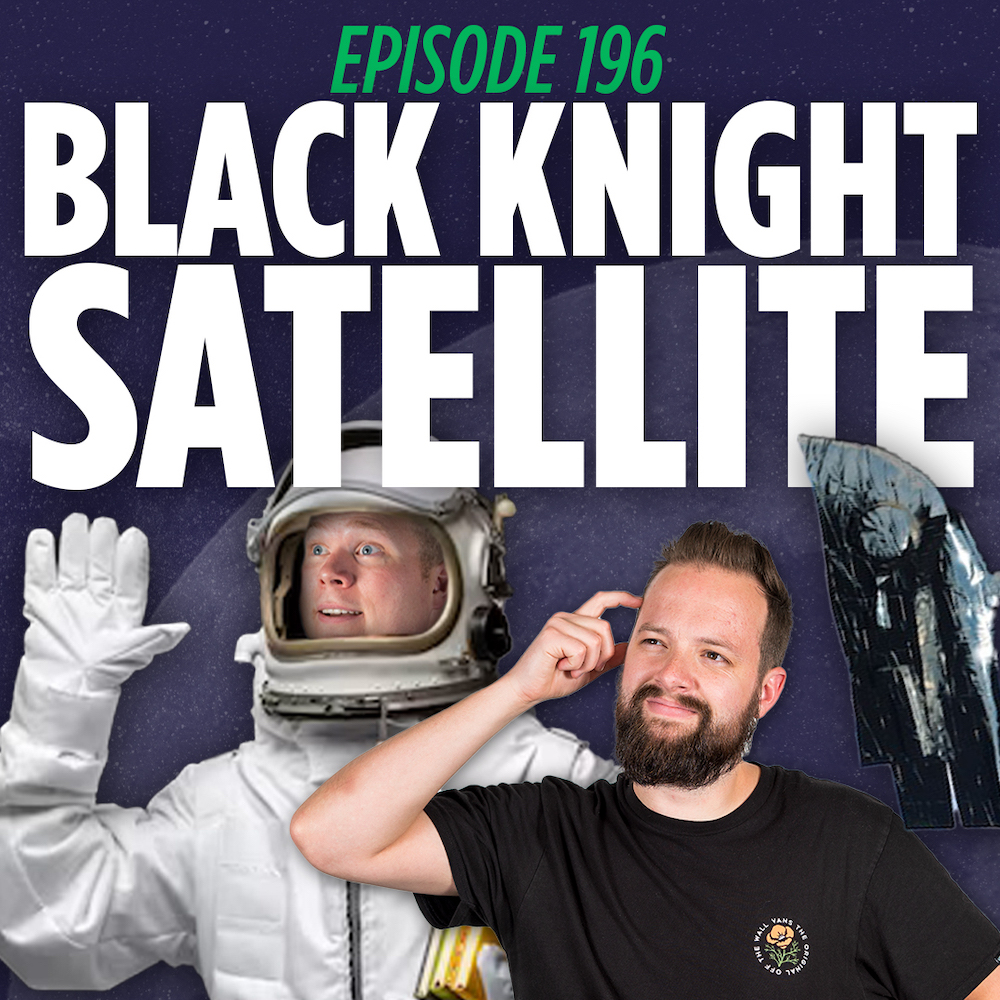 Comedy Podcasters Tim Stone and Jaron Myers stand curiously in front of the black knight satellite while Jaron wears a space suit