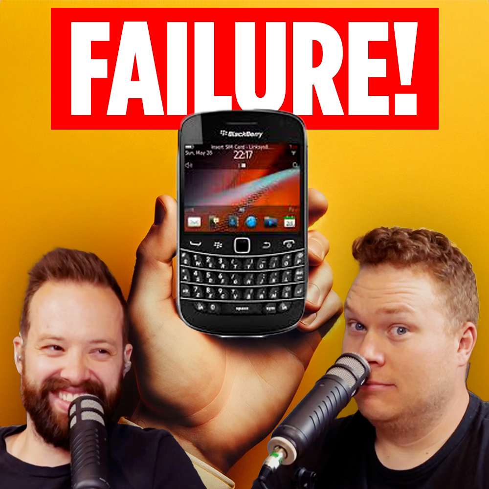 comedy podcasters tim stone and jaron myers talking on mic in front of a hand holding a blackberry phone with the banner text that reads 'failure!'