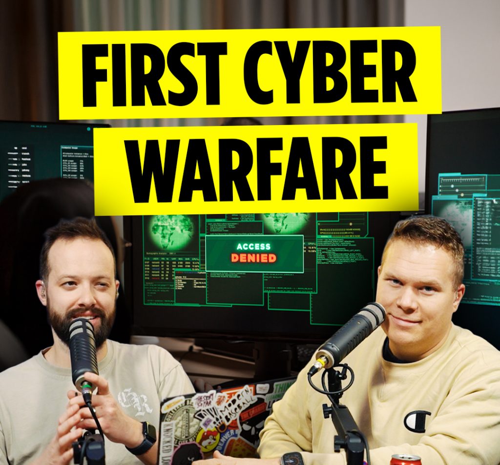 Comedy podcasters Jaron Myers and Tim Stone in front of a computer interface and a banner that reads 'first cyber warfare'
