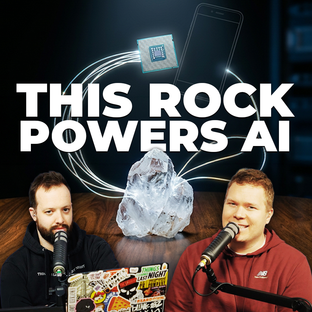 Comedy podcasters Jaron Myers and Tim Stone in front of a quartz crystal and a computer cable with a banner that reads 'this rock powers ai'